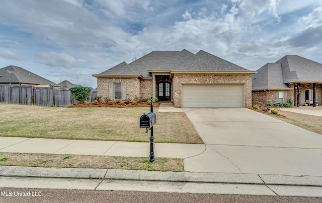 view of front facade with a garage and a front lawn