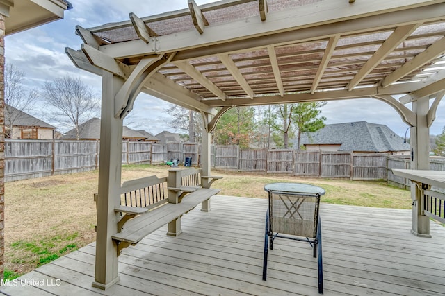 wooden deck featuring a lawn