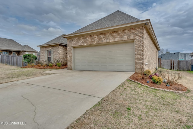 view of front of property featuring a garage and a front yard