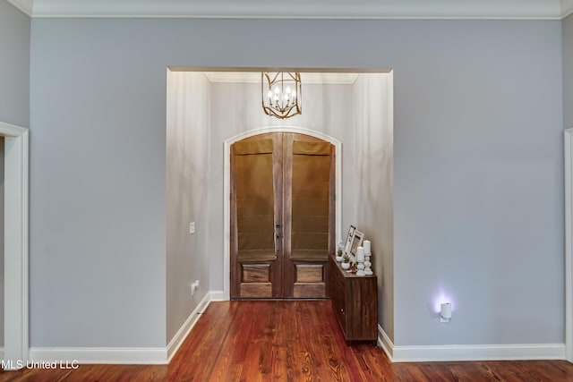 entryway featuring ornamental molding, dark hardwood / wood-style flooring, and french doors