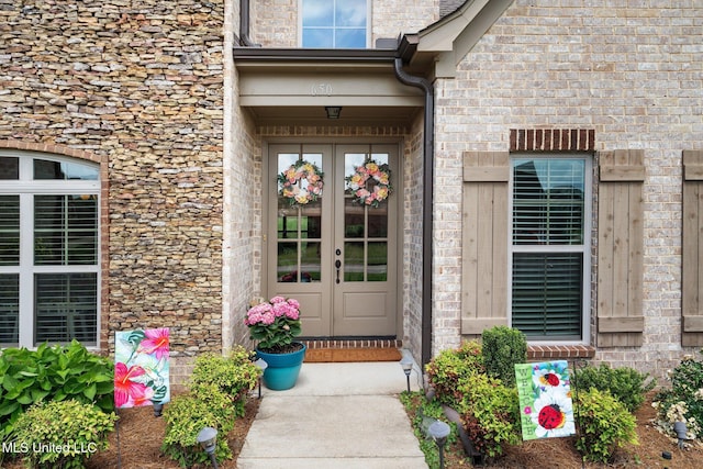 property entrance with french doors and stone siding