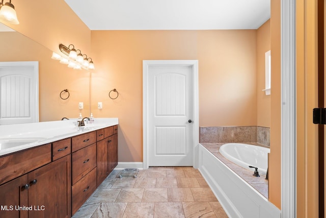 bathroom featuring double vanity, baseboards, a sink, and a garden tub