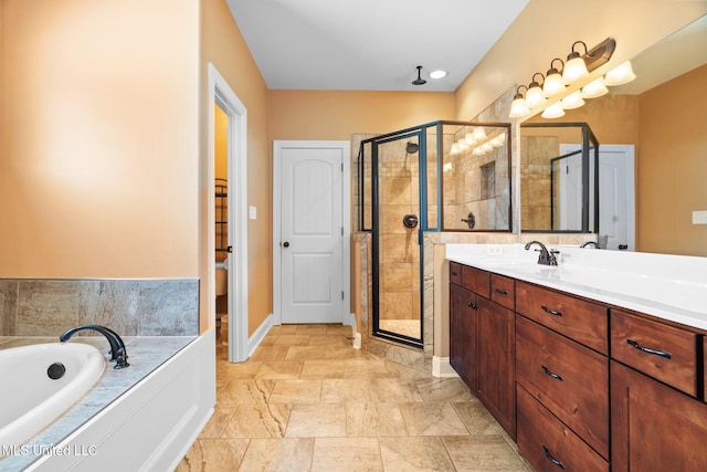 full bathroom featuring vanity, a bath, baseboards, and a stall shower
