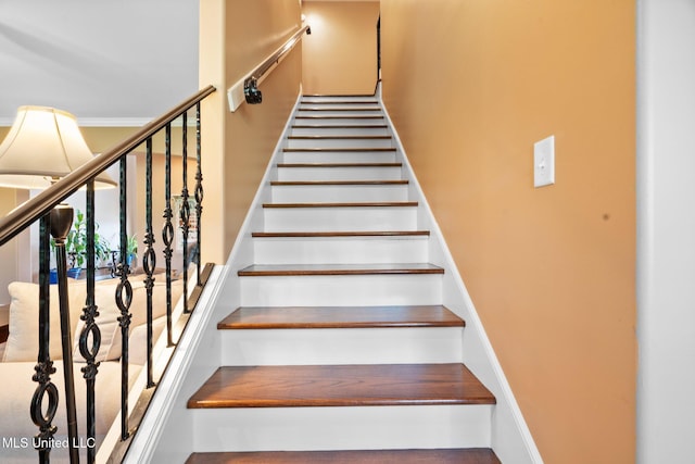 staircase featuring a towering ceiling
