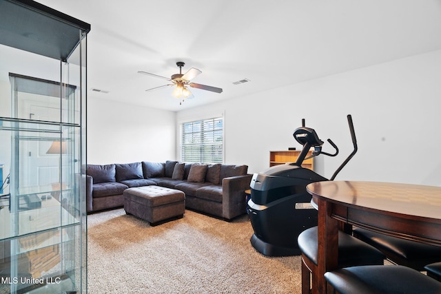living room with ceiling fan, carpet flooring, and visible vents