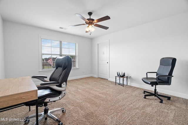 carpeted office space featuring ceiling fan, visible vents, and baseboards