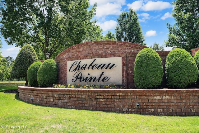 community / neighborhood sign featuring a yard
