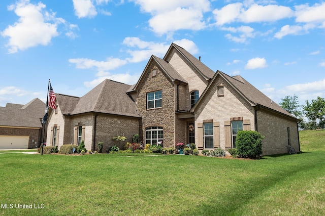 view of front of house with brick siding, a shingled roof, and a front lawn