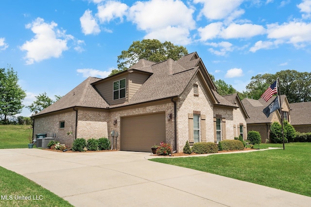 french country style house with concrete driveway, brick siding, a shingled roof, and a front yard