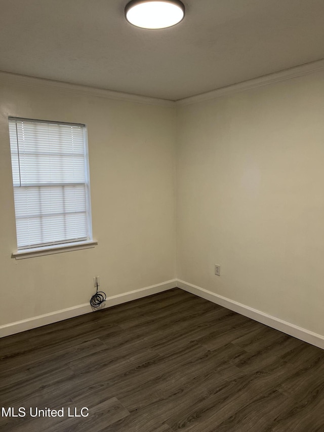 unfurnished room with dark hardwood / wood-style floors and crown molding