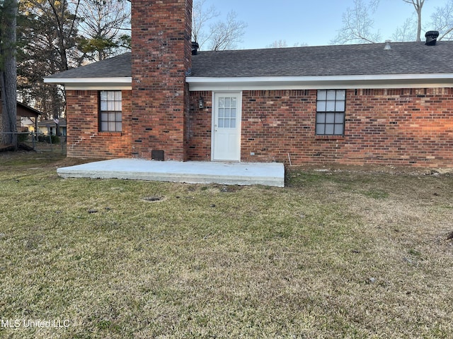 back of property featuring a yard and a patio