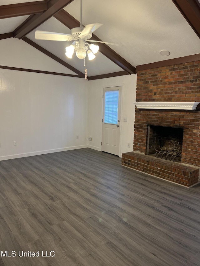 unfurnished living room with vaulted ceiling with beams, ceiling fan, a fireplace, and dark wood-type flooring