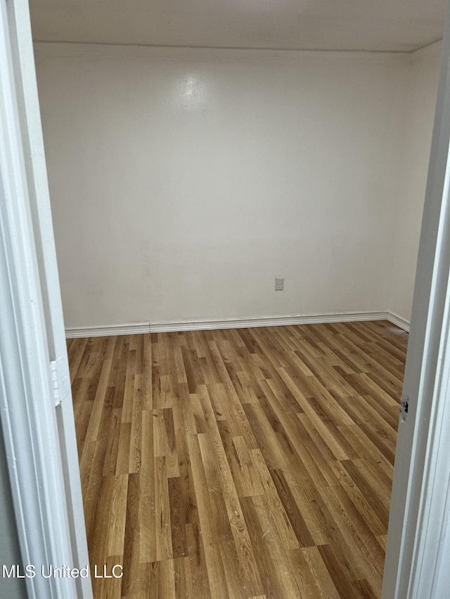 empty room with wood-type flooring