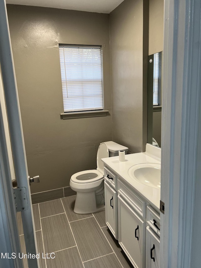 bathroom featuring vanity and toilet