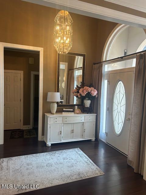 709 Oak Trl, Canton, MS 39046 - foyer entrance featuring a chandelier and dark wood-style flooring