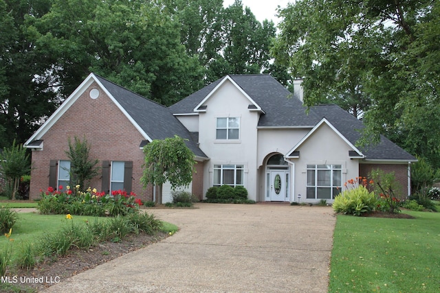 709 Oak Trl, Canton, MS 39046 - traditional home featuring a chimney, brick siding, and a shingled roof