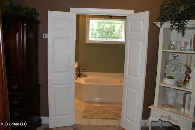 709 Oak Trl, Canton, MS 39046 - bathroom with a garden tub and tile patterned flooring