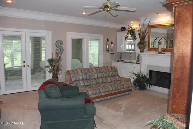 709 Oak Trl, Canton, MS 39046 - living room with french doors, light colored carpet, ceiling fan, ornamental molding, and a tiled fireplace