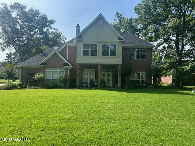 709 Oak Trl, Canton, MS 39046 - back of property with a yard and a chimney