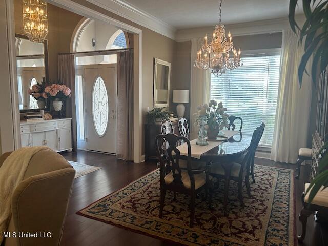 709 Oak Trl, Canton, MS 39046 - dining space featuring a chandelier, ornamental molding, and dark wood finished floors
