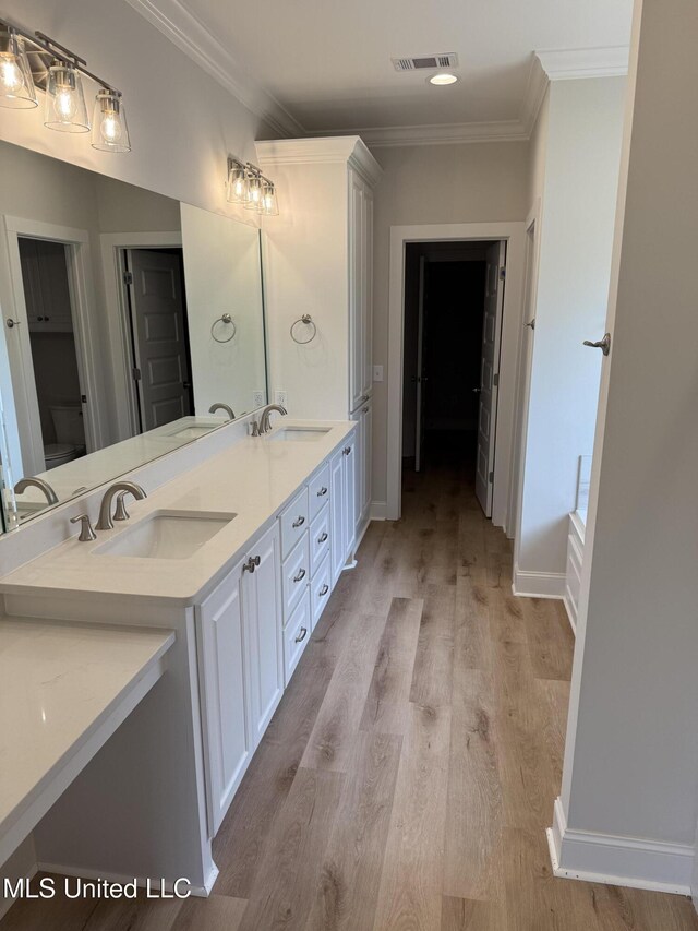 333 Willow Way, Canton, MS 39046 - full bath with double vanity, toilet, crown molding, wood finished floors, and baseboards