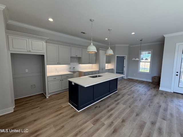333 Willow Way, Canton, MS 39046 - kitchen with light wood-style flooring, baseboards, decorative backsplash, a center island with sink, and ornamental molding