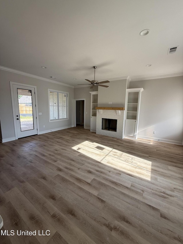 333 Willow Way, Canton, MS 39046 - unfurnished living room featuring baseboards, crown molding, wood finished floors, a ceiling fan, and a fireplace
