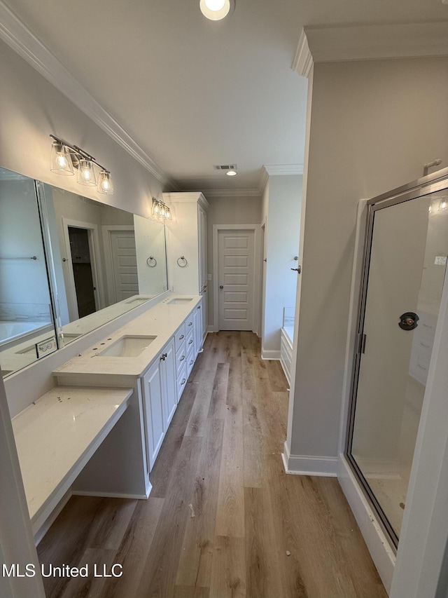 333 Willow Way, Canton, MS 39046 - full bathroom with double vanity, wood finished floors, ornamental molding, a shower stall, and baseboards