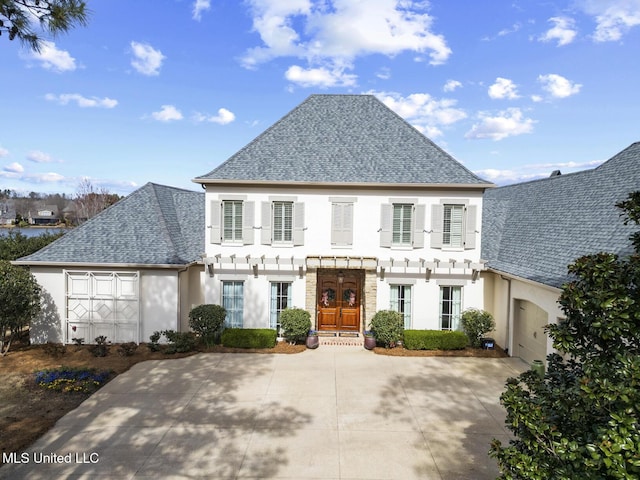 view of front of property featuring stucco siding, french doors, and a shingled roof