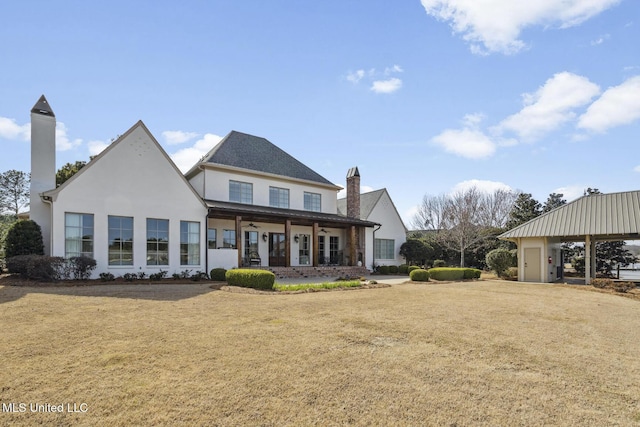 view of front of house featuring stucco siding and a front lawn