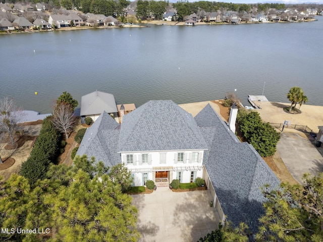 drone / aerial view featuring a residential view and a water view