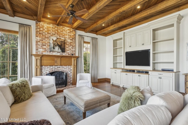 living room with a brick fireplace, baseboards, wooden ceiling, wood finished floors, and a ceiling fan