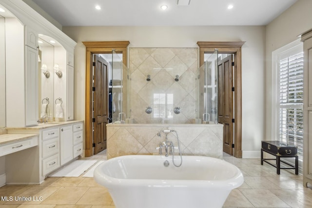 bathroom with vanity, a soaking tub, recessed lighting, a stall shower, and tile patterned floors