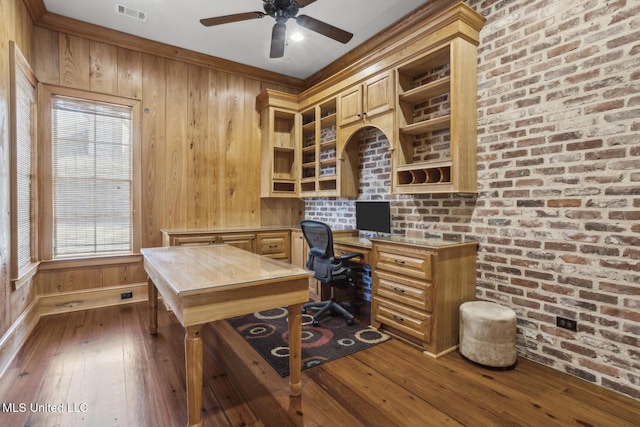 home office featuring visible vents, dark wood-style floors, brick wall, and built in study area