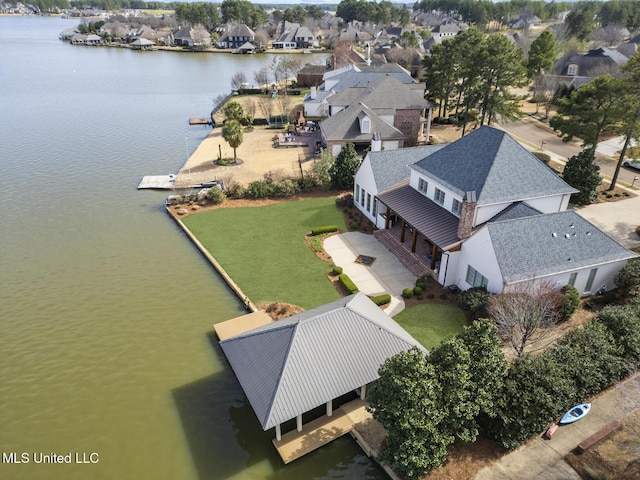 birds eye view of property with a residential view and a water view