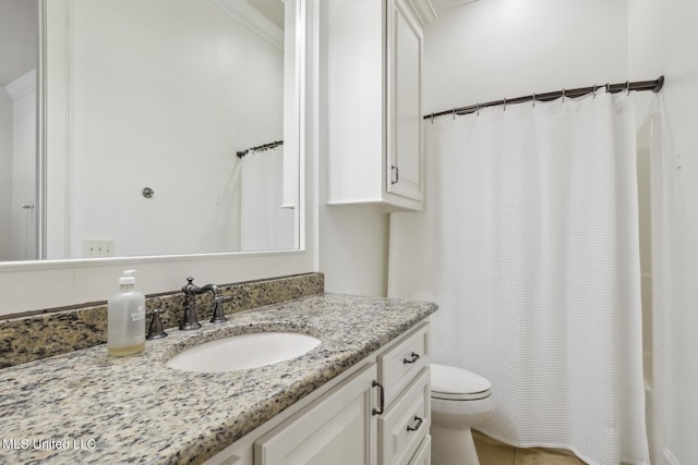 bathroom featuring toilet and vanity