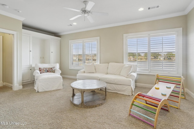 living area featuring visible vents, baseboards, carpet floors, and crown molding