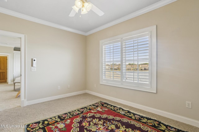 unfurnished room featuring carpet flooring, ceiling fan, baseboards, and ornamental molding