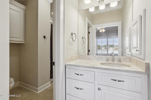 bathroom featuring tile patterned floors, toilet, vanity, and baseboards