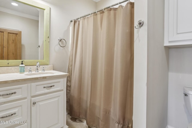 full bathroom with toilet, vanity, a shower with shower curtain, and ornamental molding