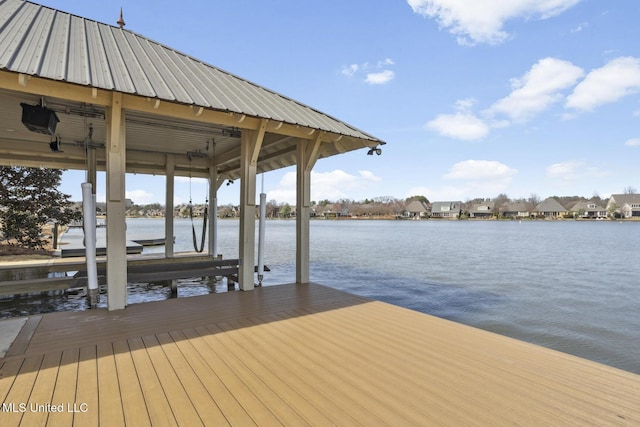 dock area with a water view and boat lift