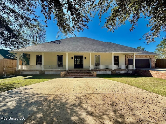 ranch-style house with a porch, a garage, and a front yard