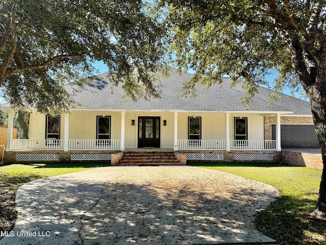 view of front of home featuring a porch and a garage