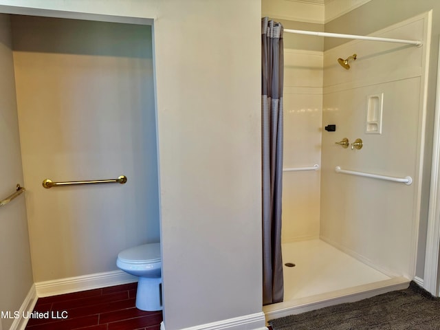 bathroom featuring wood-type flooring, toilet, and walk in shower