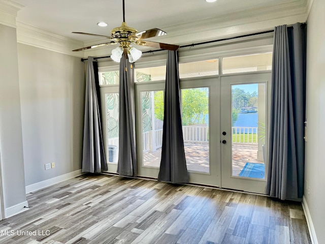 doorway featuring ceiling fan, french doors, crown molding, light hardwood / wood-style floors, and a water view