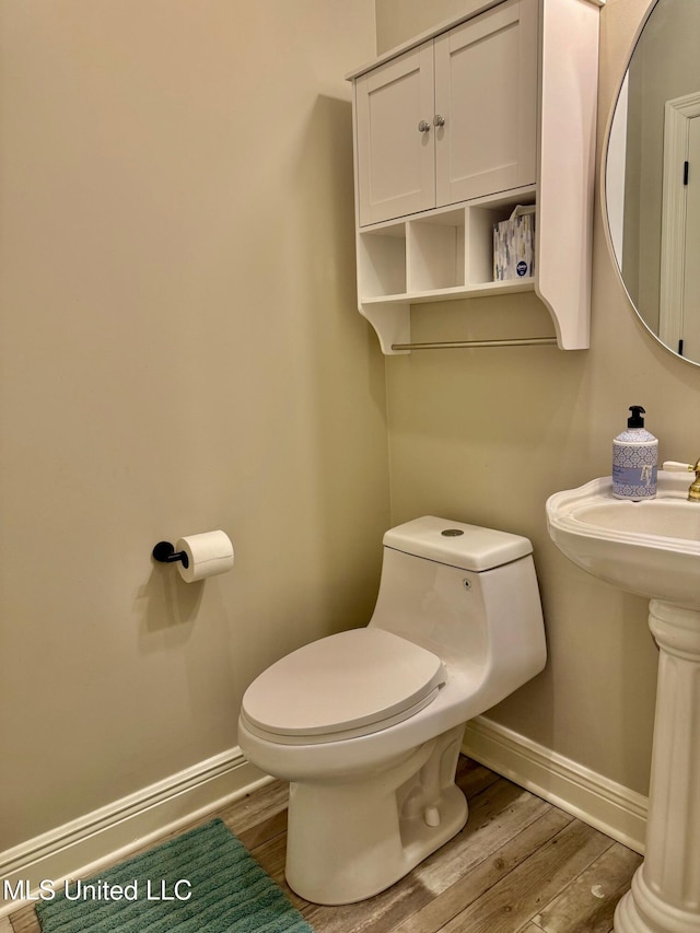 bathroom featuring toilet and hardwood / wood-style flooring