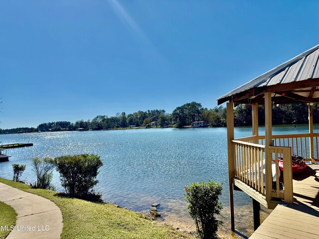 view of dock featuring a gazebo and a water view