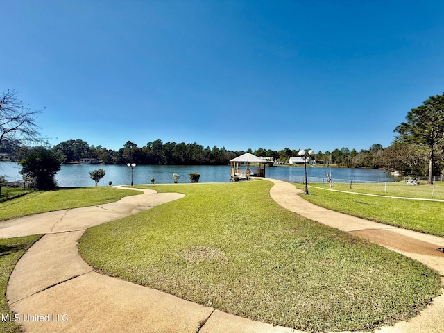 view of home's community with a yard and a water view