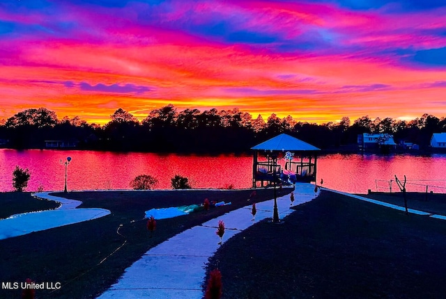 view of dock with a gazebo and a water view