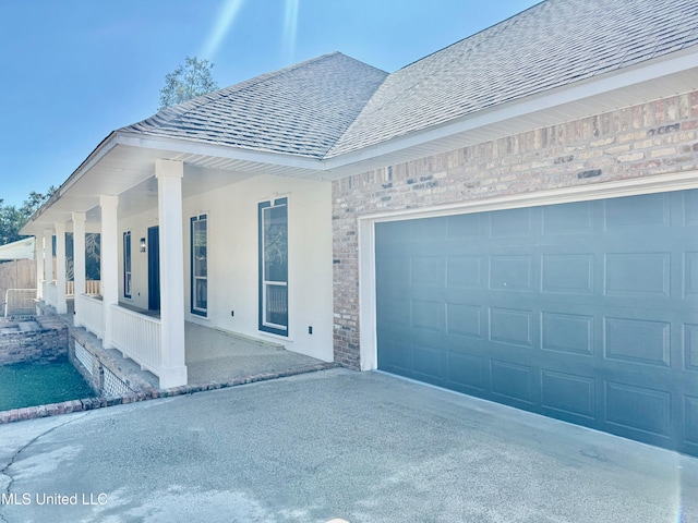 view of front of property featuring a porch and a garage